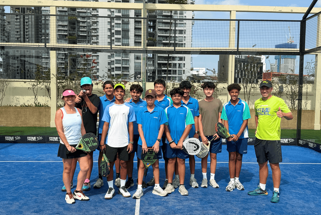 Young padel players and adults posing on a blue court